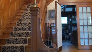 A grand staircase with a wooden handrail and a patterned carpet.