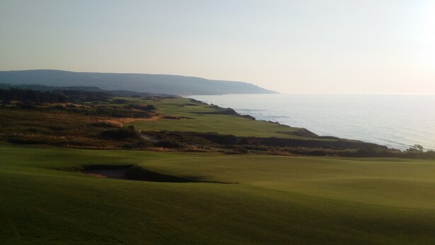A golf course with a view of the ocean and distant hills. - MacEachern 19th Hole Celtic House (Creignish)
