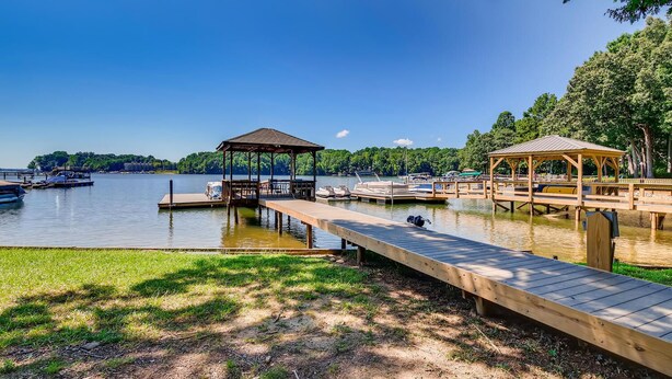 A lakeside dock with wooden walkways and gazebos, boats docked, and a grassy area. - BREATHTAKING VIEWS AT NORMANDY BREEZE! (Denver)