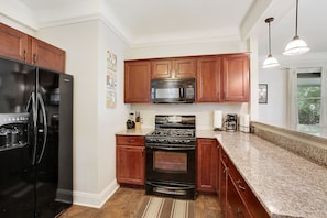 Enjoy cooking in this fully equipped kitchen with a refrigerator, microwave, and oven.