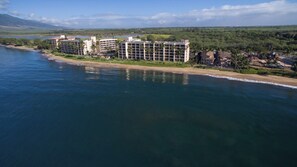 A coastal hotel with multiple buildings, a beach, and a view of the ocean. - Squeaky clean ground floor Sugar Beach #104 (Kihei)