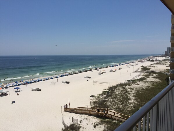 Relax on the beach with access to water activities via a wooden walkway.