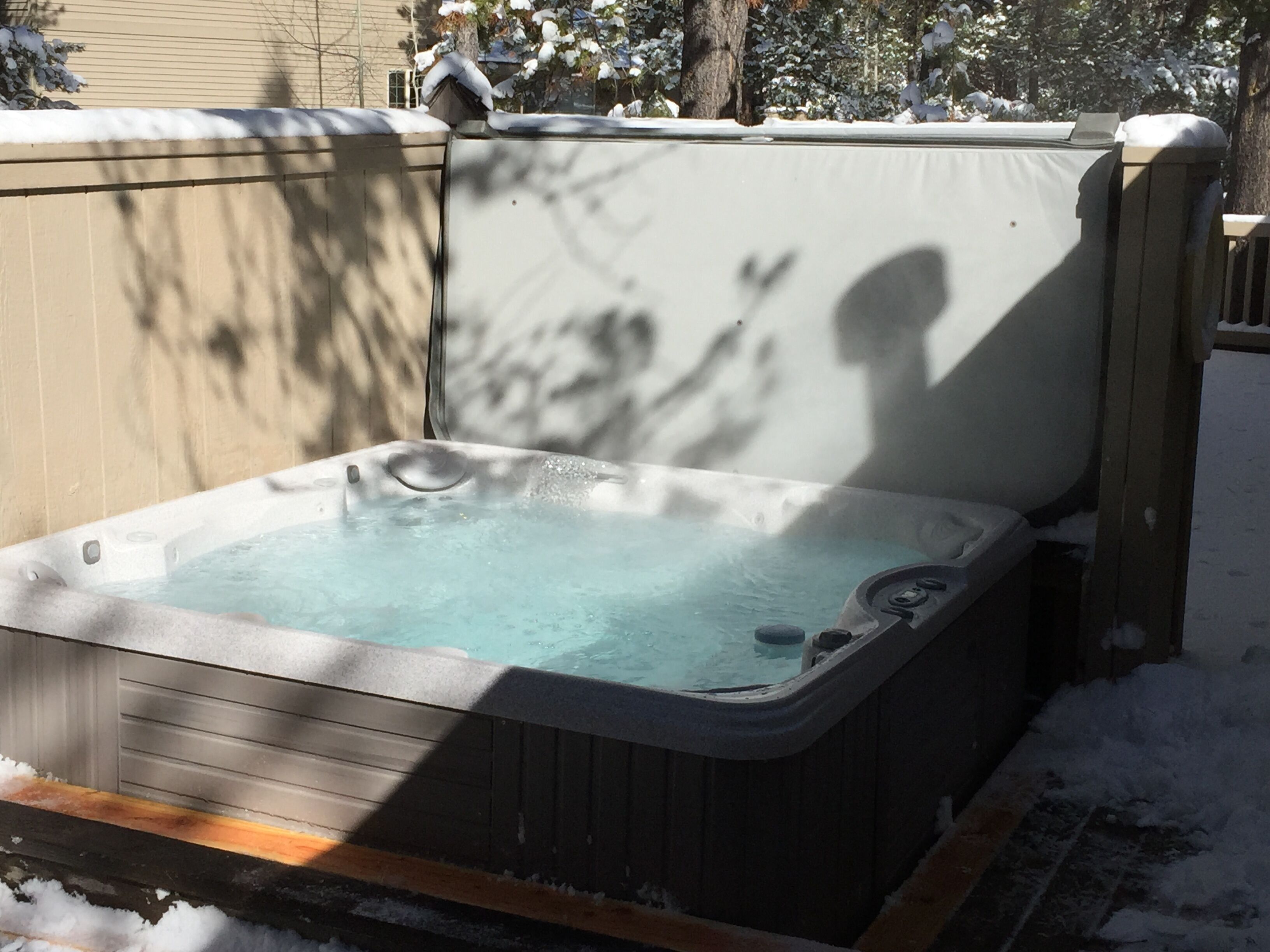 A hot tub in a snowy outdoor setting.