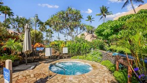 A hot tub surrounded by tropical plants and palm trees, with signs indicating it is an adult spa area. - Summer DEALS-A/C-Pool-Oceanview Building 1 ! (Kihei)
