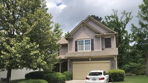 A two-story house with a garage, a driveway, and a white car parked in front. - Modern 4BR Retreat — Minutes from Mercedes-Benz Stadium - World Cup Ready (Atlanta)