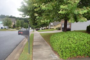 Houses line the quiet street, each with a front porch and well-maintained lawn.