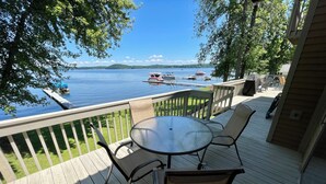 A deck with a table and chairs overlooking a lake with boats. - Lakefront Retreat near Saratoga Racetrack, SPAC (Malta)