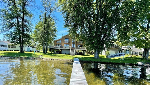 A wooden dock extending into a clear pond with a residential area in the background. - Lakefront Retreat near Saratoga Racetrack, SPAC (Malta)