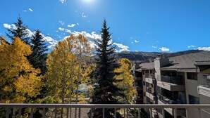 A multi-story building with balconies overlooking a mountainous landscape. - Remodeled Condo w/ FREE WiFi, Parking, Heated Pool, Hot Tubs, Skier Shuttles (Avon)