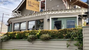 A two-story building with a sign reading "Beppe & Gianni's Traditional Italian Cuisine."