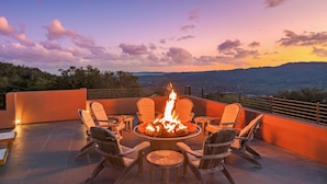 A fire pit surrounded by chairs on an outdoor terrace with a view of distant mountains. - As featured on CBS's Staycation!
Luxury Retreat Overlooking Sonoma Valley (Glen Ellen)
