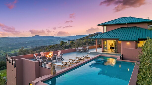 A poolside area with lounge chairs, a fire pit, and a view of the landscape. - As featured on CBS's Staycation!
Luxury Retreat Overlooking Sonoma Valley (Glen Ellen)