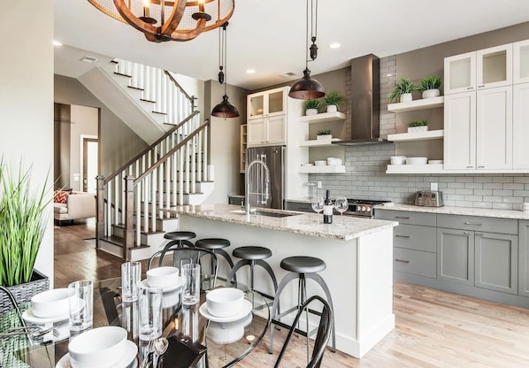 Enjoy cooking in this well-equipped kitchen with a central island, stainless steel sink, and range.