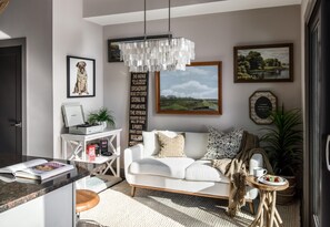 Relax in this stylish living room with a sofa, coffee table, and framed artwork.