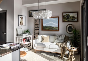 Relax in this stylish living room with a sofa, coffee table, and framed artwork.
