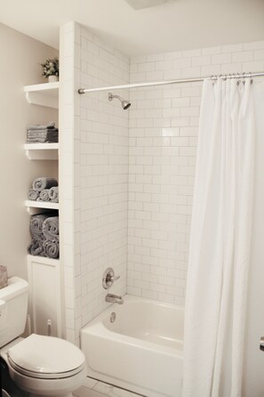 Bathtub, hair dryer, towels, soap