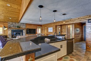 Enjoy cooking in this well-appointed kitchen with a large countertop, sink, and modern cabinetry.