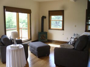 Relax in this serene living space with a stove, sofa, and dining area.