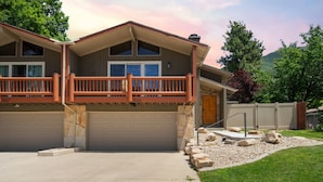 A two-story house with a balcony, two garages, and a stone foundation. - Minutes to mountains resorts & downtown SLC (cottonwood heights)