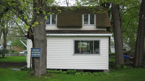 A small, single-story house with a front porch and a side window. - Bemus Point Vacation Rental (Bemus Point)