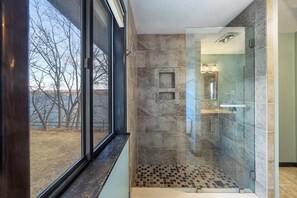 Bathtub, hair dryer, towels, toilet paper