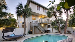 A two-story house with a balcony, a swimming pool, and outdoor furniture. - 5 STAR SIESTA KEY, 80 STEPS to BEACH, LUXURY POOL, 6 BEDROOMS, SPACIOUS LIVING (Siesta Key)