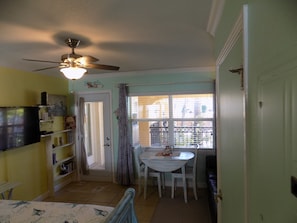 Cozy living space with a dining area, TV, and window offering a view of the outside.