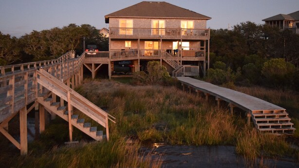 A two-story wooden house with a balcony, a wooden deck, and a staircase leading to the upper level. - SOUND FRONT!, Kite-In/Out! Sunsets! Dock!  (Salvo)