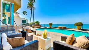 A poolside area with wicker furniture, a small pool, and a view of the ocean. - Oceanfront Beach, Pool, Hot Tub, Pickleball, Movie Theater, Elevator & Golf Cart (La Jolla)