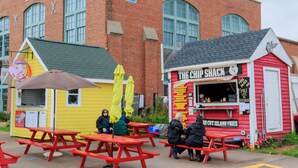 A red building with a sign that reads "The Chip Shack" and a yellow building with a sign that reads "Harbour". -  Walk to Fine Restaurants & Confederation Centre of The Arts. (Charlottetown)