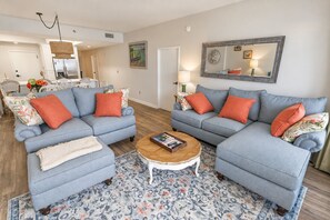 A living room with two sofas, a coffee table, and a patterned rug. - Gulf-Front Tides Unit 202 | 2BR | Sleeps 6 (Miramar Beach)