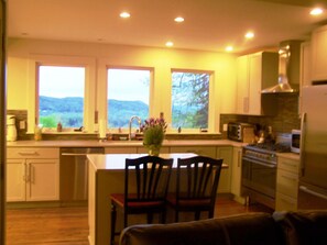 Enjoy cooking in this well-equipped kitchen with a central island, sink, and stove, plus a microwave.
