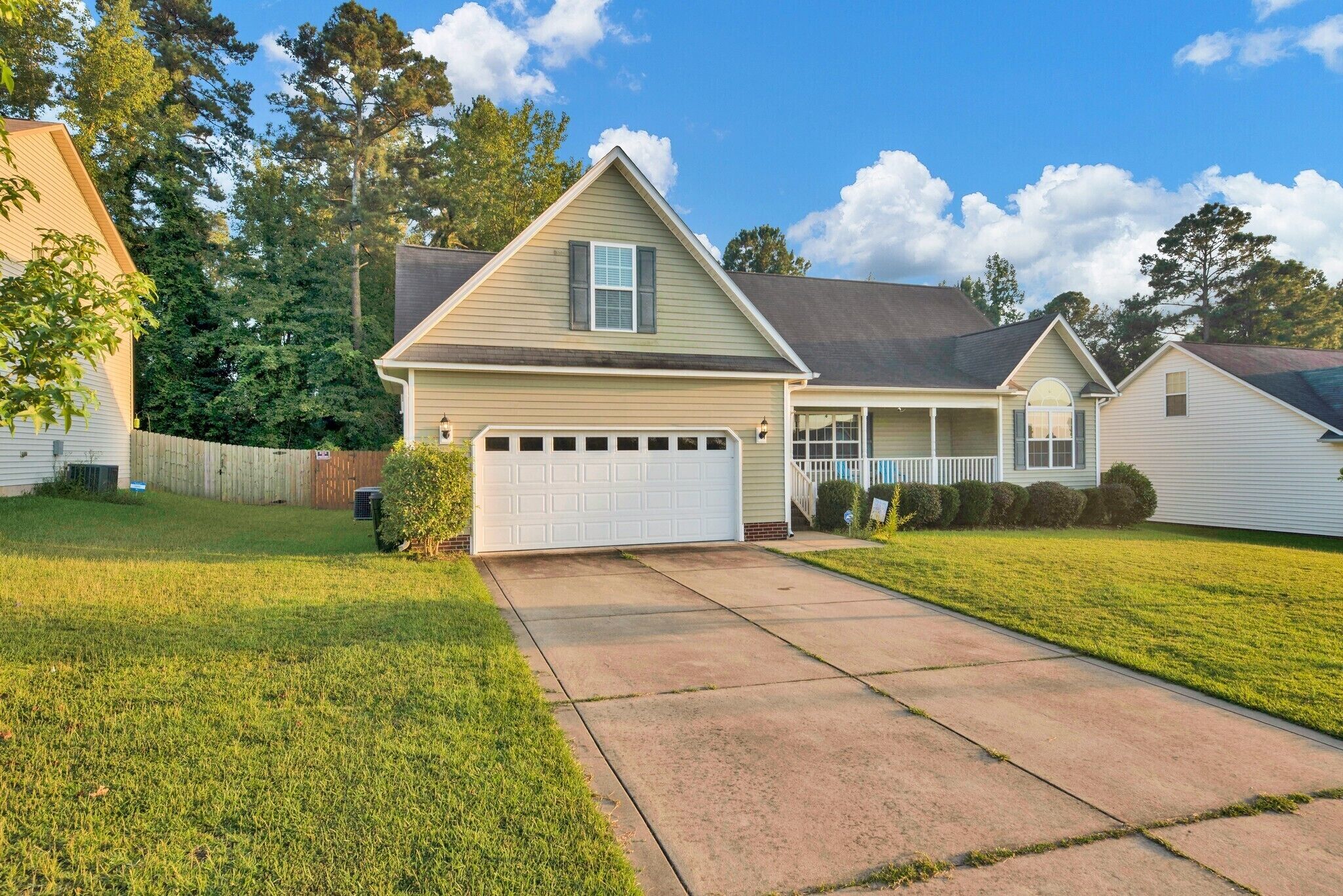 A single-story house with a garage, a front porch, and a well-maintained lawn.