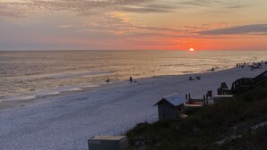 A beach with a sunset, a small wooden structure, and a grassy area. - In the Heart of Rosemary Beach - Beach, Pool, & Shops Steps Away (Rosemary Beach)