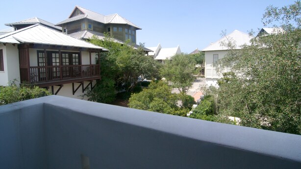 A residential area with multiple houses, including a house with a balcony and a house with a sloped roof. - In the Heart of Rosemary Beach - Beach, Pool, & Shops Steps Away (Rosemary Beach)