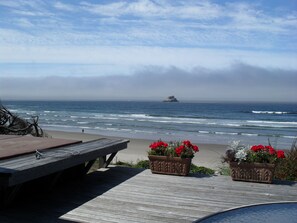 A wooden deck with a bench and flower planters overlooking the ocean. - Oceanfront, Amazing View, Hot Tub Facing Ocean (Arch Cape)