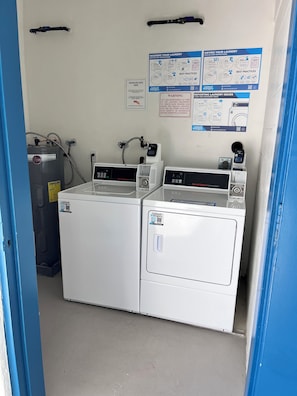 A laundry facility with two washing machines and a water heater, along with instructional posters on the wall. - MILLION DOLLAR VIEW with a ROOM. UPDATED August 26 Penthouse Floor. Happy Guests (Marco Island)
