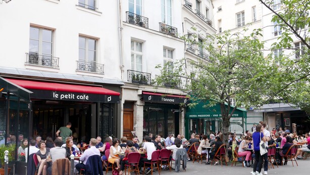 An outdoor café with tables and chairs, surrounded by buildings. - LATIN QUARTER, PARIS VIEW, 30–60 days ahead? Ask for a private offer. C5-VAs (Paris)