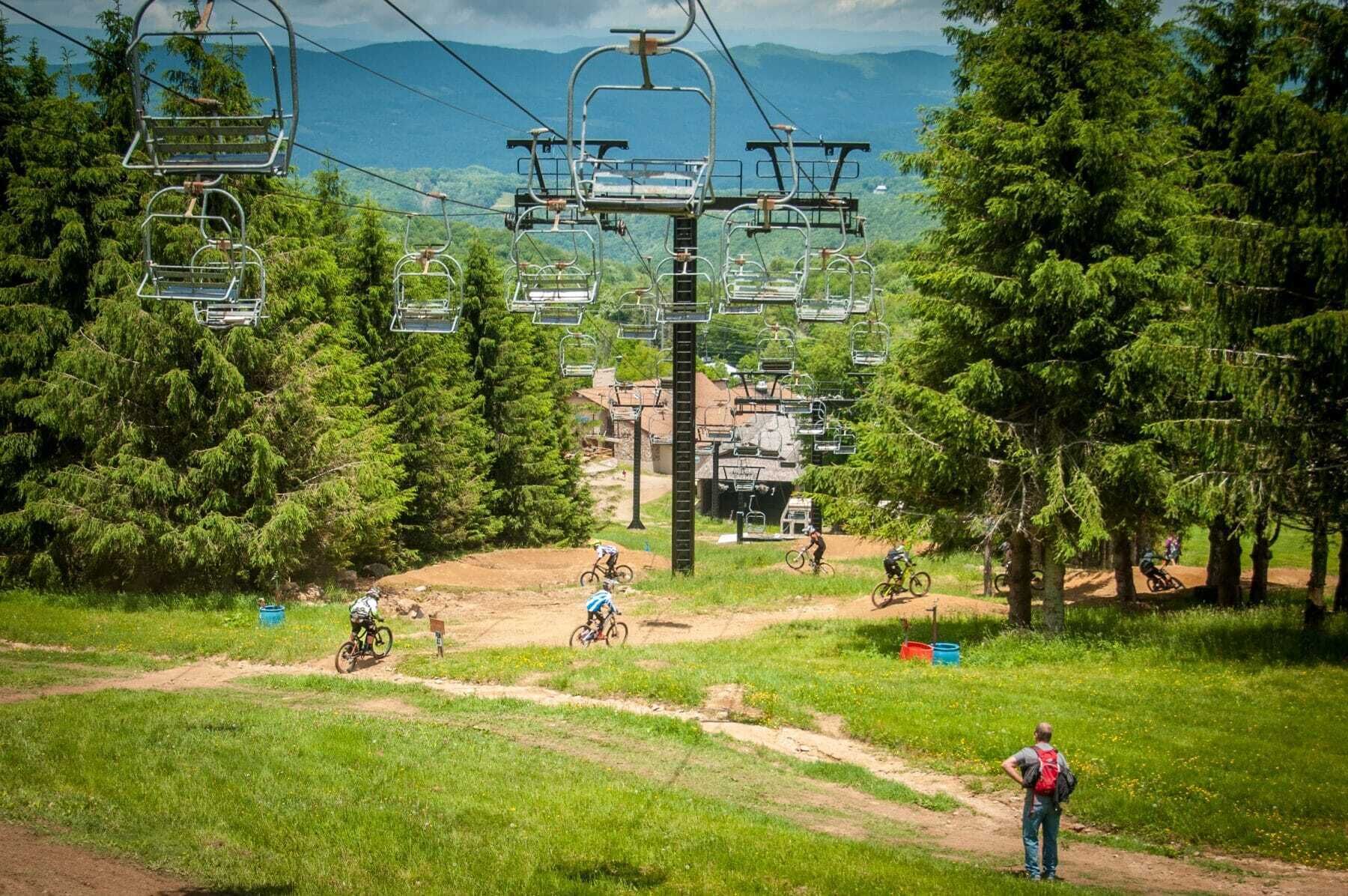 A mountain biking trail with a ski lift in the background.