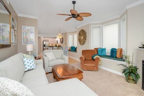 A living room with a ceiling fan, a sofa, a chair, and a coffee table. - Beautiful 3BR Unit, 1/2 Block to the Beach and Close to Everything You Need! (Ocean City)