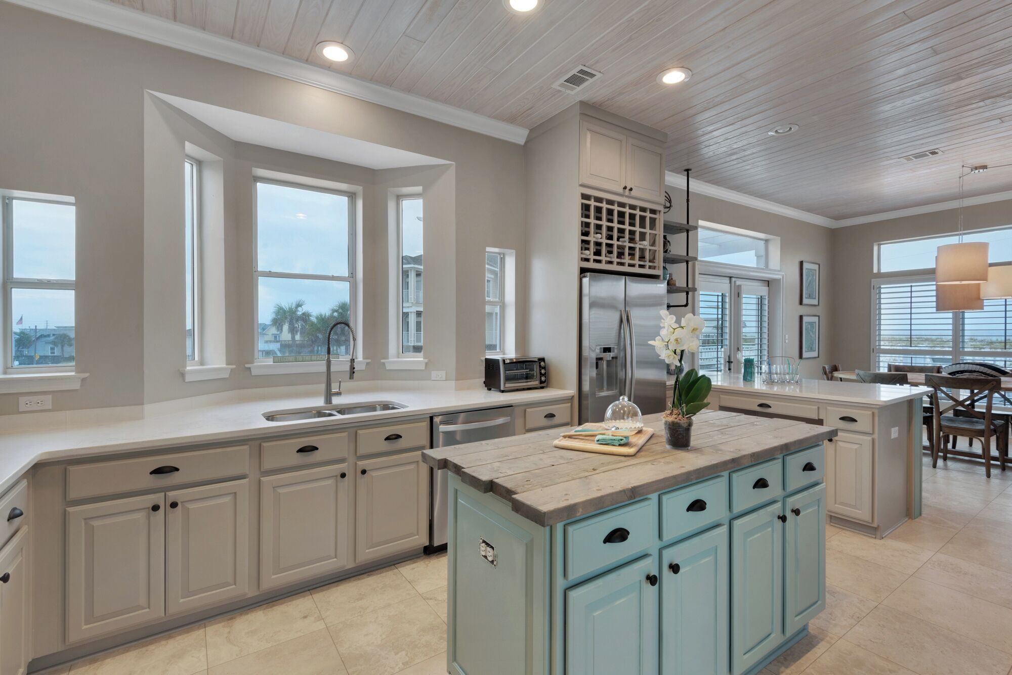 A spacious kitchen with a large island, built-in appliances, and ample natural light from large windows.