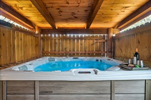 A wooden cabin with a hot tub, wooden walls, and a wooden ceiling. - Hidden Treasure in the heart of Pigeon Forge
50.00 off a night jan. and feb. (Pigeon Forge)