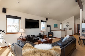 A living room with a fireplace, a sofa, a coffee table, and a television.