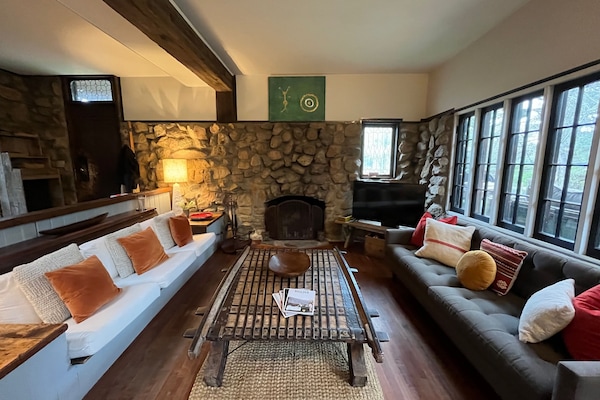 Living room with wall of windows to the outdoors