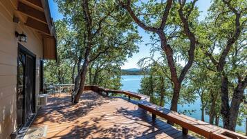 Enjoy a scenic view from this deck overlooking the water.