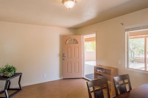 Cozy retreat with a wooden door, table, and bookshelf, perfect for relaxation and reading.