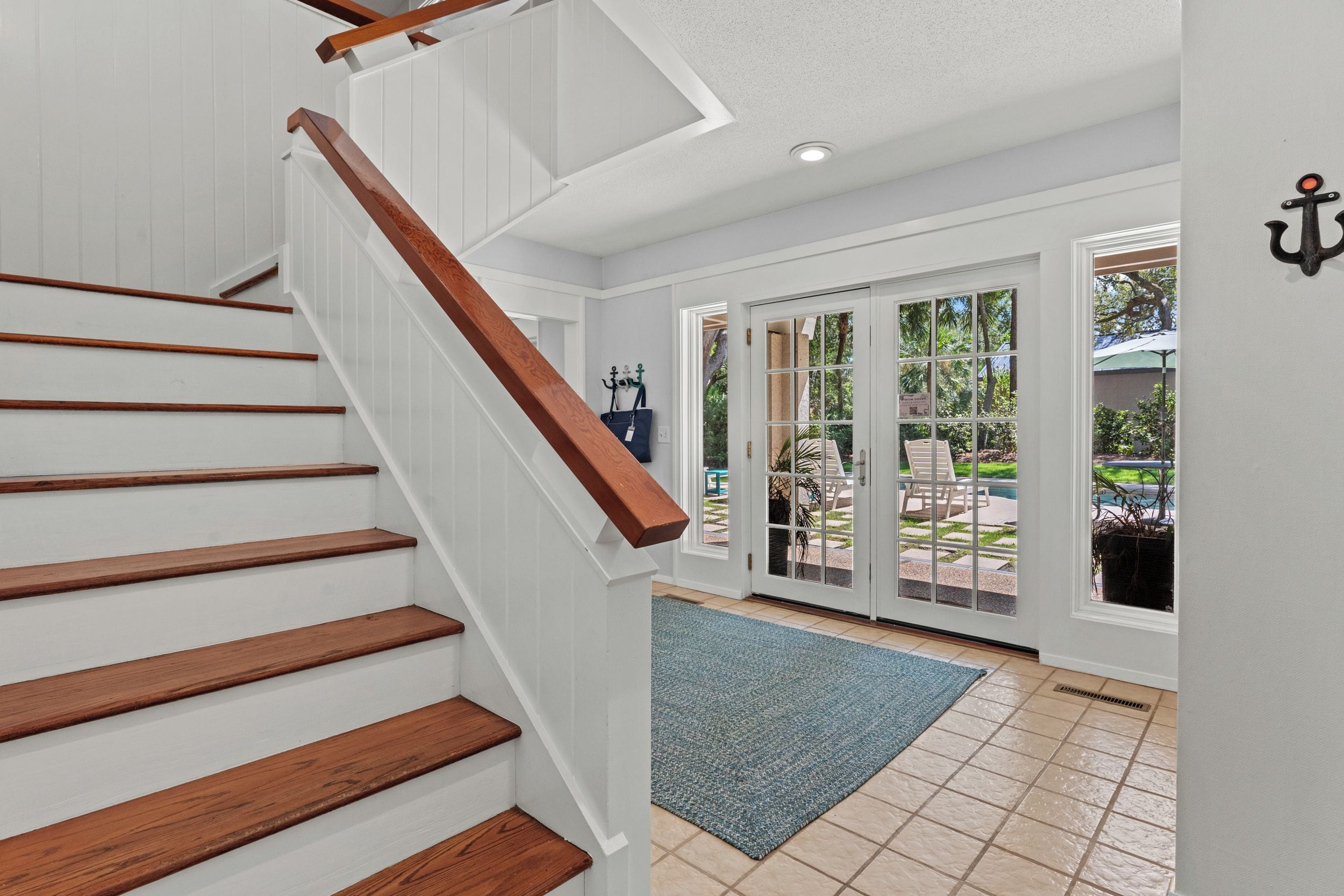 A staircase with wooden steps and a white wall.