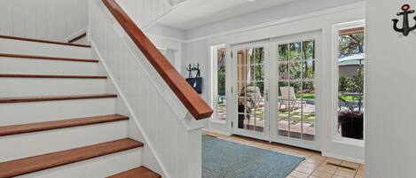 A staircase with wooden steps and a white wall.