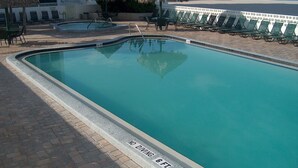A swimming pool with a no diving sign, lounge chairs, and a view of the beach. - Fantastic Gulf View! On the beach! 3 Bdrms, 3 Baths, Great Pool and Hot Tub (Redington Shores)