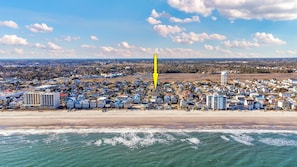 An aerial view of a coastal town with beachfront properties, a water tower, and a dense residential area. - Grand Ocean Getaway 2 ,Ocean Views, Private Pool! (North Myrtle Beach)